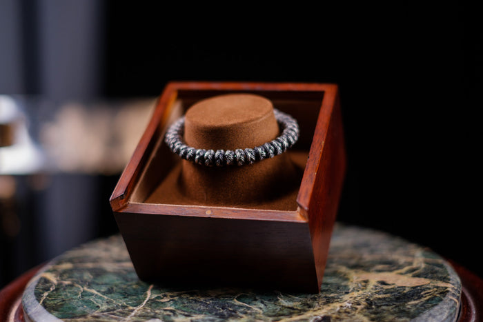 A Lenrok bracelet in its wooden box