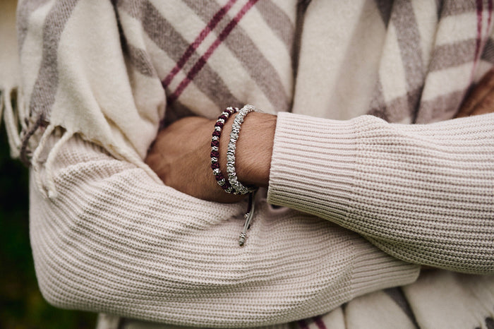 Silver bracelet worn with a cream knit sweater