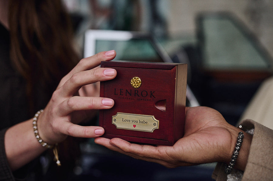 Hands holding the engraved Lenrok box